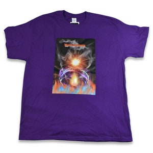 May include: Purple t-shirt with a graphic print of a bright orange and yellow sun with smoke and flames. The text "Welcome Into Madness" is printed on the graphic.