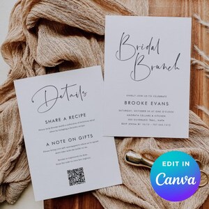 May include: Two white cards with elegant calligraphy announcing a bridal brunch. One card says "Details" and includes a QR code. The other card says "Bridal Brunch" and lists event details. The cards rest on a beige fabric.