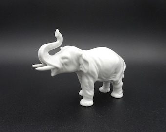 Glossy White Porcelain Elephant Figurine with Raised Trunk