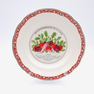 May include: A white ceramic plate with a decorative red and floral border. The centre of the plate features a radish illustration and French text, including "Les Radis" and "Les Gastronomiques de la Sante."