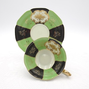 Nippon Yoko Boeki Co. Hand Painted Green and Black Paneled Tea Cup and Saucer with Gold Enameled Floral Medallion Made in Japan