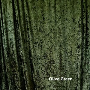 May include: A close-up of a textured, olive green fabric backdrop. The fabric has a slightly crinkled appearance, giving it a unique and rustic look.