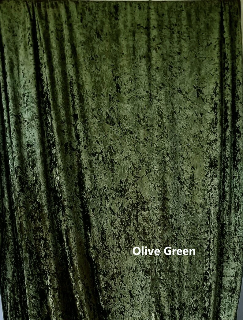 May include: A close-up of a textured, olive green fabric backdrop. The fabric has a slightly crinkled appearance, giving it a unique and rustic look.