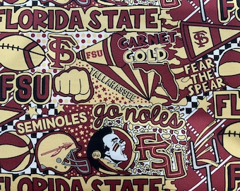 May include: A colorful fabric with a repeating pattern of Florida State University logos, including the school mascot, the Seminole Indian, and the words "FSU", "Seminoles", "Garnet Gold", "Fear the Spear", and "Tallahassee".