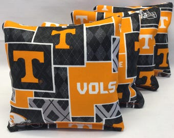 May include: Set of four orange, black, and gray bean bags with a Tennessee Volunteers logo and the word "VOLS".