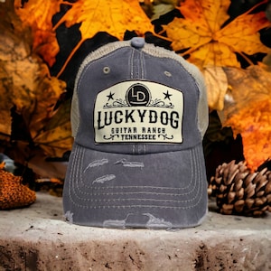 Lucky Dog distressed low profile Trucker Ball Cap w/ soft, gray crown/gray bill and beige mesh back. Slide buckle. Multiple patch options.