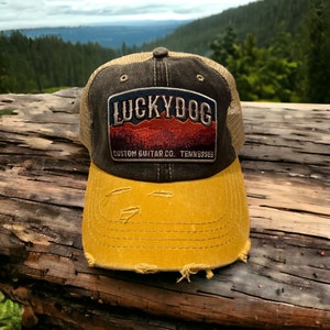 Lucky Dog distressed low profile Trucker Ball Cap w/ soft, dark denim crown/gold bill/beige mesh back. Slide buckle-multiple patch options