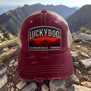 May include: A white ceramic mug with a black handle and the text "But First, Coffee" in a bold, black font. The mug is set against a blurred background, suggesting a cozy setting. The mug appears to be approximately 4 inches tall.