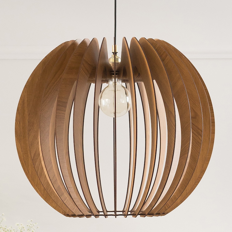 May include: A round wooden pendant light with a geometric design. The light is made of thin wooden slats that are arranged in a radial pattern. The light has a single bulb in the center.