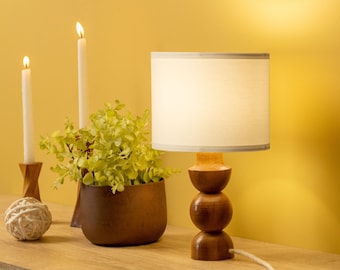 Handcrafted Wooden Table Lamp - Warm Illumination, Captivating Style for Living Rooms & Bedrooms. Illuminate your space with natural beauty.