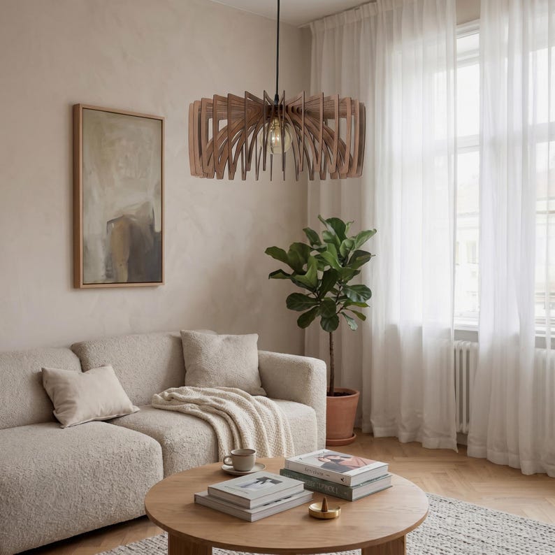 May include: A circular pendant light fitting constructed from thin, vertical wooden slats arranged in a radial pattern. The light features a central exposed bulb suspended by a black cord, creating a structured, layered appearance with natural wood tones.