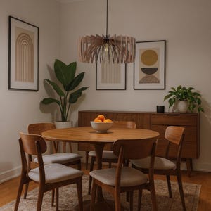 May include: A circular wooden pendant light fitting with vertical slats suspended from the ceiling above a round wooden dining table. The table is surrounded by four wooden chairs with light grey upholstered seats and a wooden sideboard.