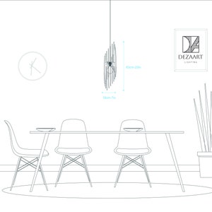 May include: A black metal pendant light fixture with a circular design hangs from the ceiling above a dining table with four chairs. The light fixture is 18cm wide and 63cm tall. The text "DEZAART LIGHTING" is visible in the top right corner of the image.