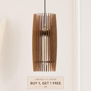 May include: A cylindrical pendant light fixture constructed from vertical brown wooden slats arranged around a central clear glass tubular light bulb. The fixture is suspended by a thin black cord and features a metallic gold socket component.