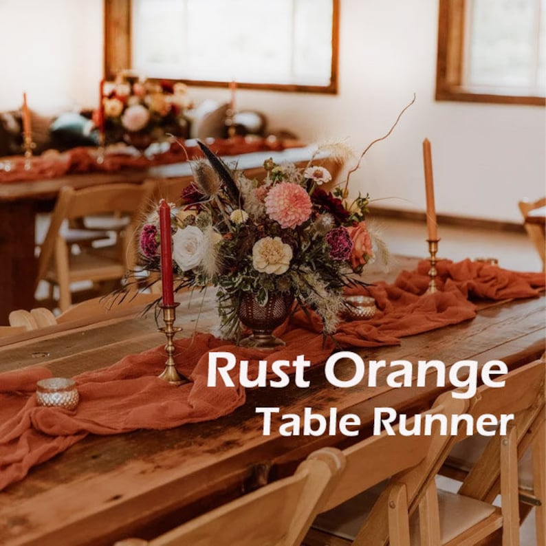May include: A rustic wooden table with a rust orange table runner, a floral centerpiece, and two candlesticks. The text "Rust Orange Table Runner" is superimposed on the image.