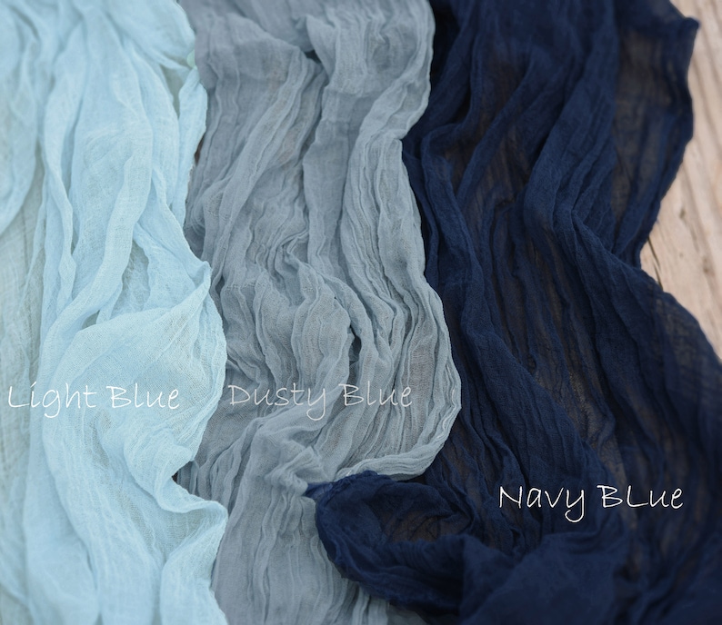 May include: Three swatches of fabric in different shades of blue. The swatches are labeled "Light Blue", "Dusty Blue", and "Navy Blue".