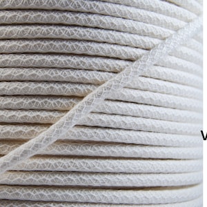 May include: Close-up of a spool of white cotton cord. Available in 3mm, 4mm, 5mm, and 6mm. Various lengths available.