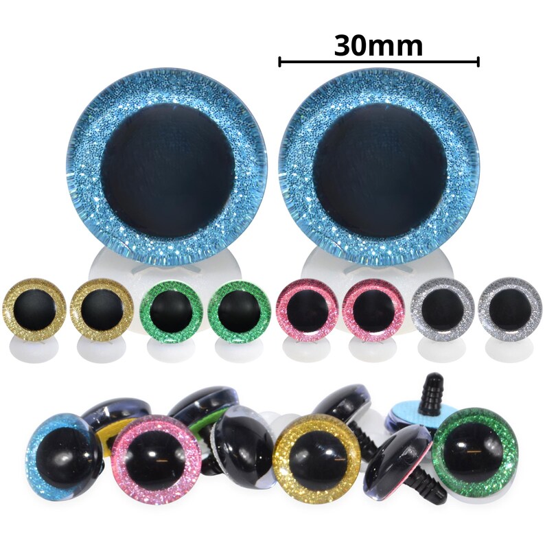 May include: A collection of colorful craft eyes in various sizes and colors, including blue, gold, green, pink, and silver. The largest pair of eyes measures 30mm across. The eyes have a glittery, sparkly finish and a black pupil.