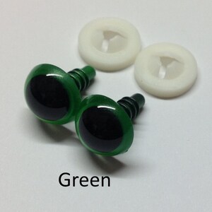 May include: Two green plastic safety eyes with black pupils and a metal shank. The eyes are accompanied by two white plastic washers.