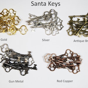 Könnte beinhalten: Sortiment antiker Skelettschlüssel in fünf verschiedenen Ausführungen: Gold, Silber, Antikbronze,  Metallgrau und Rotkupfer.  Santa Keys.