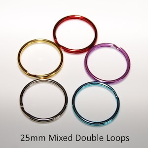 May include: Five 25mm double loop key rings in assorted colours: red, gold, purple, silver, and blue.