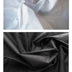 May include: Two fabric samples: one white, one black. The white fabric is light and airy, with soft folds. The black fabric has a subtle shimmer and a textured appearance. Text at the bottom reads: Lightweight Interfacing - 112cm wide.