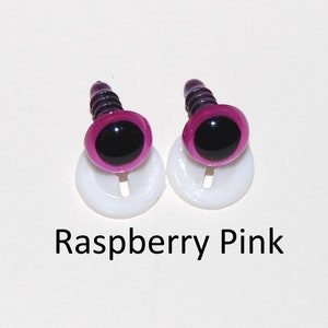 May include: Two raspberry pink plastic safety eyes with black pupils and white plastic washers. The eyes are on a white background.