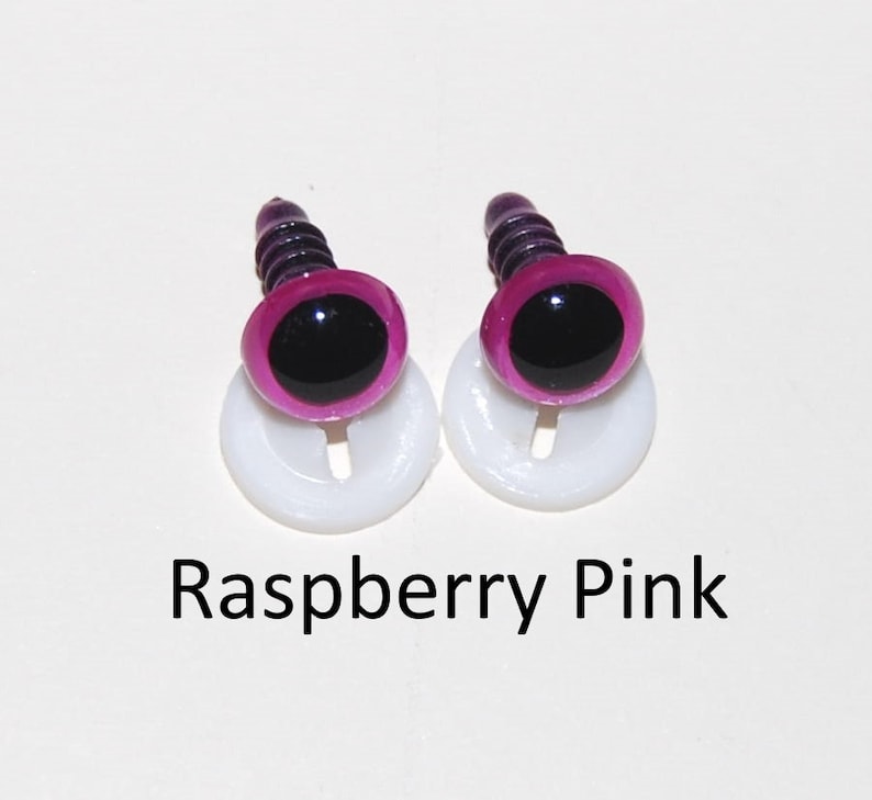 May include: Two raspberry pink plastic safety eyes with black pupils and white plastic washers. The eyes are on a white background.