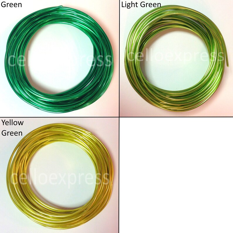 May include: Four spools of wire in different colors: green, light green, yellow green, and white. The wire is coiled into circles.