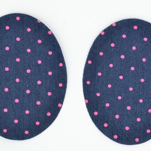 May include: Two blue oval-shaped fabric patches with pink polka dots.