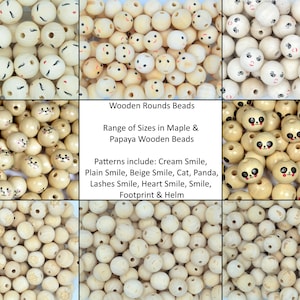 May include: Assortment of wooden beads with various painted designs, including smiles, cats, pandas, and hearts. The beads are in shades of cream and beige. Wooden Rounds Beads, Range of Sizes in Maple & Papaya Wooden Beads, Patterns include: Cream Smile, Plain Smile, Beige Smile, Cat, Panda, Lashes Smile, Heart Smile, Smile, Footprint & Helm.