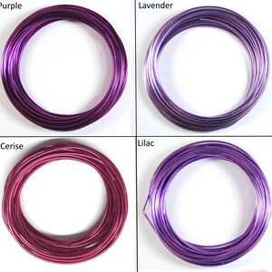 May include: Four spools of colorful wire in shades of purple, lavender, cerise, and lilac. The wire is wound into a circle and is ready for crafting projects.