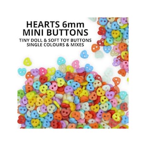 May include: A selection of 6mm heart-shaped mini buttons in a variety of colours. The image shows buttons in shades of red, yellow, blue, pink, and orange. Text on the image reads: "HEARTS 6mm MINI BUTTONS TINY DOLL & SOFT TOY BUTTONS SINGLE COLOURS & MIXES."