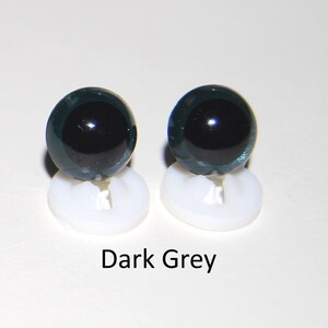 May include: Two dark grey plastic safety eyes with black pupils, mounted on white plastic bases.  Dark Grey.