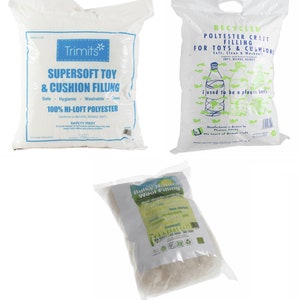 May include: Three bags of different types of filling for toys and cushions. The first bag is white and says "Trimits Supersoft Toy & Cushion Filling Safe Hygienic Washable Clean 100% Hi-Loft Polyester". The second bag is white with blue and green text and says "Recycled Polyester Craft Filling for Toys & Cushions Soft, Clean & Washable EN71, 851425, 855857 i used to be a plastic bottle". The third bag is white with green text and says "Bulky Natural Wool Filling Wool absorbs moisture naturally".