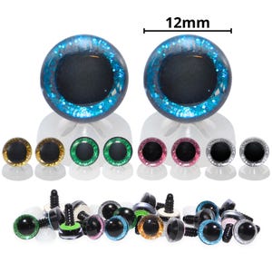 May include: A collection of craft eyes in various colors, including blue, gold, green, pink, and silver. The top row features two large 12mm blue eyes. The bottom row shows the eyes with black plastic fasteners. These are ideal for crafting and toy making.