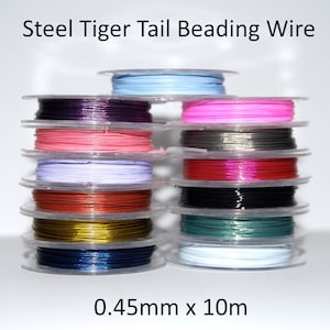 May include: A stack of spools of steel tiger tail beading wire in various colours, including pink, red, blue, green, gold, and silver. The wire is 0.45mm thick and 10 metres long.