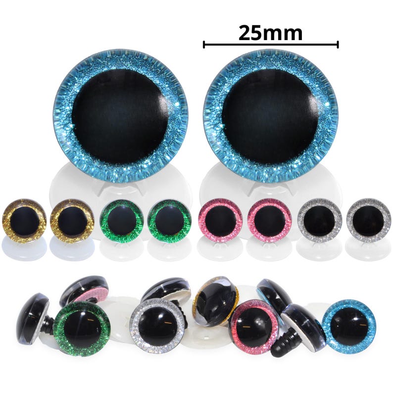 May include: A collection of craft eyes in various colors, including blue, gold, green, pink, and silver. The largest pair of eyes are 25mm in diameter. Each eye has a black pupil and a glittery, colored iris.