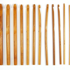 May include: Set of 10 bamboo crochet hooks in various sizes, ranging from 3.5 mm to 8.0 mm. The hooks are made of natural bamboo and have a smooth, polished finish.