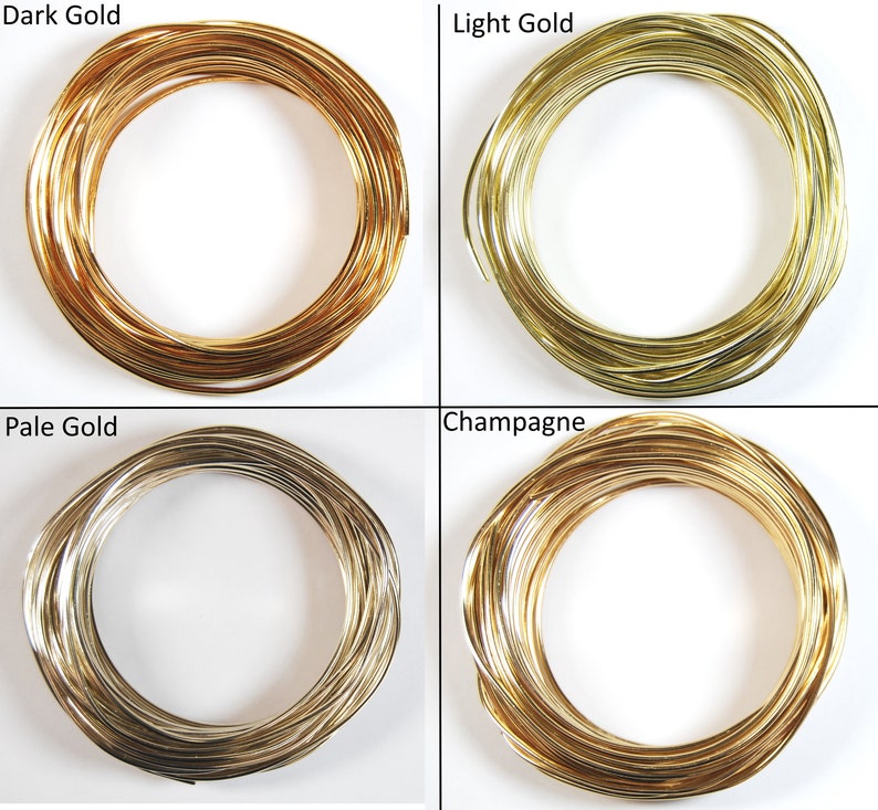 May include: Four spools of gold wire in different shades: dark gold, light gold, pale gold, and champagne.