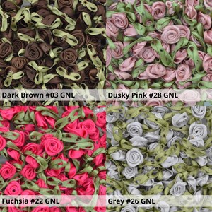 May include: Assortment of small fabric flower embellishments in various colors, including dark brown, dusky pink, fuchsia, and grey. Each flower has a green ribbon attached.