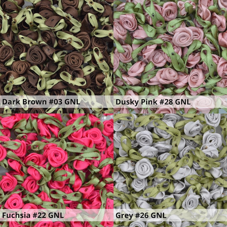 May include: Assortment of small fabric flower embellishments in various colors, including dark brown, dusky pink, fuchsia, and grey. Each flower has a green ribbon attached.