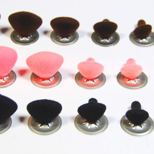 May include: Assortment of plush safety eyes in various sizes. The eyes are available in brown, pink, and black colours. Each eye has a metal backing.