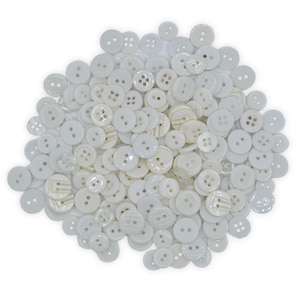 May include: A large pile of white plastic buttons of various sizes and styles.