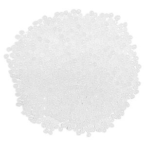 May include: A close-up view of a pile of small, translucent, round beads. The beads are scattered across the frame, creating a dense, textured surface. The beads appear to be made of a clear, glossy material.