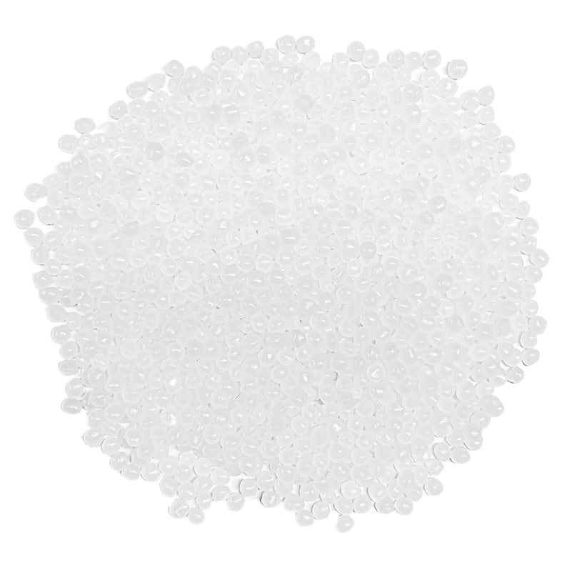 May include: A close-up view of a pile of small, translucent, round beads. The beads are scattered across the frame, creating a dense, textured surface. The beads appear to be made of a clear, glossy material.