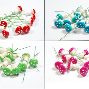 May include: Assortment of miniature mushroom figurines with white polka dots on red, green, blue, and pink caps. Each mushroom is attached to a green wire stem.