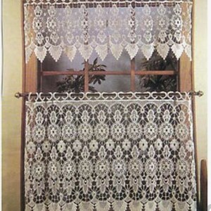 Pu&ograve; includere: Tende in pizzo bianco con un delicato motivo floreale. Le tende sono appese a una finestra con una cornice in legno.