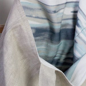May include: A beige linen tote bag with a blue and white striped lining. The bag has a small label that says "RedLinen".