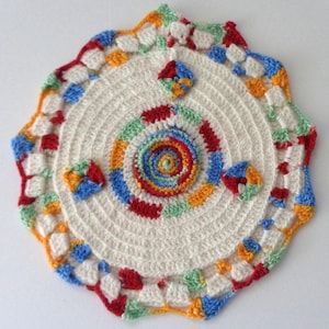 May include: A handmade, off-white crochet doily with a spiral center and colorful accents. The doily features a concentric design with red, blue, green, and yellow details. The scalloped edge is trimmed with a vibrant mix of colors, adding a playful touch.